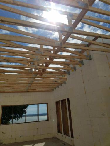 Another view of top chord pitch designed roof trusses supported by the IFH28-11.